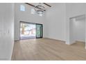 Bright living room showcasing expansive sliding glass doors, and modern flooring and high ceilings at 2826 Barrow Downs St, Las Vegas, NV 89135