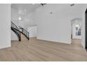 Spacious living room featuring soaring ceilings, elegant staircase and contemporary wood-look flooring at 2826 Barrow Downs St, Las Vegas, NV 89135