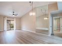 Bright living room features vaulted ceilings, modern light fixture, and an expansive mirror accent wall at 2851 S Valley View Blvd # 1195, Las Vegas, NV 89102
