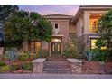 Charming home showcasing a stone facade, desert landscape, and double door entry at 3010 Hammerwood Dr, Las Vegas, NV 89135