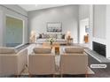 Bright living room showcasing neutral tones, plush seating and a fireplace that creates a cozy atmosphere at 3142 Espanol Dr, Las Vegas, NV 89121