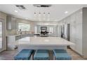 Bright, updated kitchen with quartz countertops, large island with seating, stainless steel appliances, and pendant lighting at 4 Tarryall Ter, Henderson, NV 89074