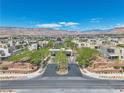 Panoramic aerial view of a Primary-planned community with mountains in the distance under a bright sky at 4277 Sunrise Flats St, Las Vegas, NV 89135