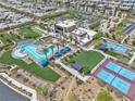 Aerial view of a community pool and recreation center, complete with pool, tennis courts, and lush lawns at 4277 Sunrise Flats St, Las Vegas, NV 89135