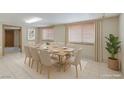 Bright dining room with seating for ten, and large windows provide ample natural light at 5262 Harris Ave, Las Vegas, NV 89110