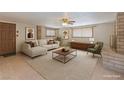 Virtually staged living room with neutral tones, modern furniture, and lots of natural light at 5262 Harris Ave, Las Vegas, NV 89110