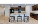 Kitchen features granite countertops, dark cabinets, a kitchen island and stainless steel appliances at 5412 Dalle Valley St, North Las Vegas, NV 89031