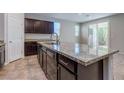 Kitchen island features stainless steel dishwasher, granite countertops and dark cabinets at 5412 Dalle Valley St, North Las Vegas, NV 89031