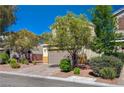 Street view of home showing desert landscaping and a two-car garage and neutral paint at 5852 Brown Tree Ln, North Las Vegas, NV 89081
