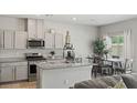Modern kitchen with stainless steel appliances, granite countertops, and a cozy dining area at 7819 Rachelis St, North Las Vegas, NV 89084