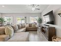 Spacious living room with tile floors, stylish sectional, and plenty of natural light at 7819 Rachelis St, North Las Vegas, NV 89084