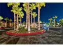 Well-maintained community entrance at night with tall palm trees and manicured landscaping at 8250 N Grand Canyon Dr # 2154, Las Vegas, NV 89166