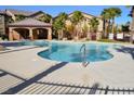 Community pool with clear blue water, ample seating, and an open-air pavilion at 8250 N Grand Canyon Dr # 2154, Las Vegas, NV 89166