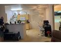 Open-concept living space featuring neutral carpeting, ceiling fan, and access to the kitchen at 8250 N Grand Canyon Dr # 2154, Las Vegas, NV 89166