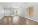 Bright living room boasting hardwood floors, large windows, and a welcoming entryway at 8847 W Katie Ave, Las Vegas, NV 89147