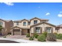 Inviting two-story home featuring neutral stucco, stone accents, and a two-car garage at 8953 Hitch Creek St, Las Vegas, NV 89131