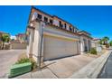 Exterior view of home showing two-car garage and front entrance at 9165 Starling Wing Pl, Las Vegas, NV 89143
