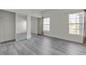 Bright bedroom features gray floors, white walls, and mirrored closet doors at 9330 W Maule Ave # 212, Las Vegas, NV 89148