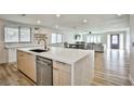 Bright and modern kitchen with an island, open to the living room, featuring quartz countertops and stainless steel appliances at 9340 W Washburn Rd, Las Vegas, NV 89149