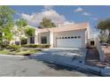 Inviting single-story home featuring a two-car garage, tile roof, and well-kept landscaping for curb appeal at 9404 Calico Garden Ave, Las Vegas, NV 89134