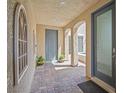 Inviting entryway with decorative archways and columns leading to a private courtyard with spa at 9654 Ponderosa Skye Ct, Las Vegas, NV 89166