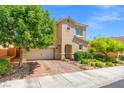 Lovely two-story home featuring mature trees, brick paver driveway, and lush landscaping at 9654 Ponderosa Skye Ct, Las Vegas, NV 89166