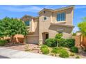 Beautiful two-story home with blue shutters, a brick paver driveway, and mature trees at 9654 Ponderosa Skye Ct, Las Vegas, NV 89166