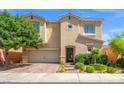 Two-story home featuring a well-maintained lawn, brick driveway, and neutral stucco exterior at 9654 Ponderosa Skye Ct, Las Vegas, NV 89166