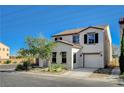 This is a charming two-story home boasting a stucco exterior, tile roof, and an attached one-car garage at 9931 Cherry Melee Ave, Las Vegas, NV 89148