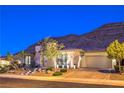 This charming home features a paved driveway, attached garage and desert landscaping at 10149 Terrastone Dr, Las Vegas, NV 89148
