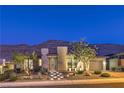 Contemporary home features a landscaped front yard, lighted walkway and mountain views at 10149 Terrastone Dr, Las Vegas, NV 89148