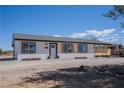 Cozy single-story home featuring a covered outdoor area and desert-friendly landscaping at 1050 Bruce St, Pahrump, NV 89048