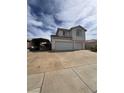 Two-story home with a three-car garage and an adjacent car port at 128 Appian Way, Henderson, NV 89002