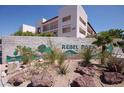 A view of Rebel Park Condominiums, showcasing landscaping and building exterior at 1381 E University Ave # 310, Las Vegas, NV 89119