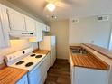 Kitchen with plentiful wooden countertops and white appliances, including stove and refrigerator at 1381 E University Ave # 310, Las Vegas, NV 89119