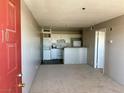 Inviting living room with neutral carpet and an eat-in kitchen with white appliances at 1381 E University Ave # 310, Las Vegas, NV 89119