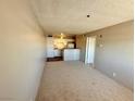 A well lit living room and kitchen area offers a seamless living experience at 1381 E University Ave # 310, Las Vegas, NV 89119