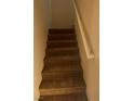 Carpeted staircase with white handrail leading to the upper level of the home at 1434 Summer Glow Ave, Henderson, NV 89012