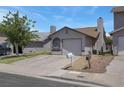 Single-story home featuring a stucco facade, arched windows, and a one-car garage at 1622 Lorna Dr, Henderson, NV 89011