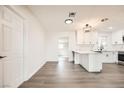 Modern kitchen featuring white cabinets, stone countertops, stainless steel appliances, and updated flooring at 1829 E Saint Louis Ave, Las Vegas, NV 89104