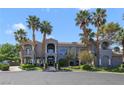 Eye-catching two-story house with manicured lawns and many palm trees at 1931 Pago Ct, Las Vegas, NV 89117