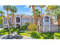 Attractive two-story house featuring manicured lawns and tall palm trees at 1931 Pago Ct, Las Vegas, NV 89117