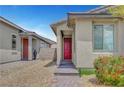 Inviting front entrance featuring a red door and brick walkway at 2238 Thelen Ave, North Las Vegas, NV 89086
