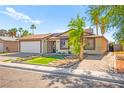 Charming single-story home featuring a two-car garage, desert landscaping, and a welcoming facade at 251 Las Palmaritas Dr, Las Vegas, NV 89110