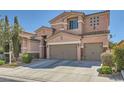 Two-story house with desert landscaping featuring a two car garage and a well maintained lawn at 280 Goldstar St, Henderson, NV 89012