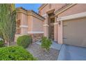 Close up of the front door and landscaping of a two story house with a two car garage at 280 Goldstar St, Henderson, NV 89012