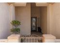 Inviting covered front porch with decorative iron gate and custom door at 3522 Shonna Way, North Las Vegas, NV 89032