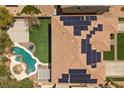 Home with solar panels, beautiful pool, covered patio, and green lawn from an aerial perspective at 358 Whispering Tree Ave, Las Vegas, NV 89183
