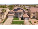 Expansive home with a solar panel system, well-maintained lawn, and neatly arranged landscaping at 358 Whispering Tree Ave, Las Vegas, NV 89183