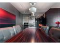 Contemporary dining area featuring a stainless kitchen, unique lighting, and modern artwork at 4381 W Flamingo Rd # 2122, Las Vegas, NV 89103